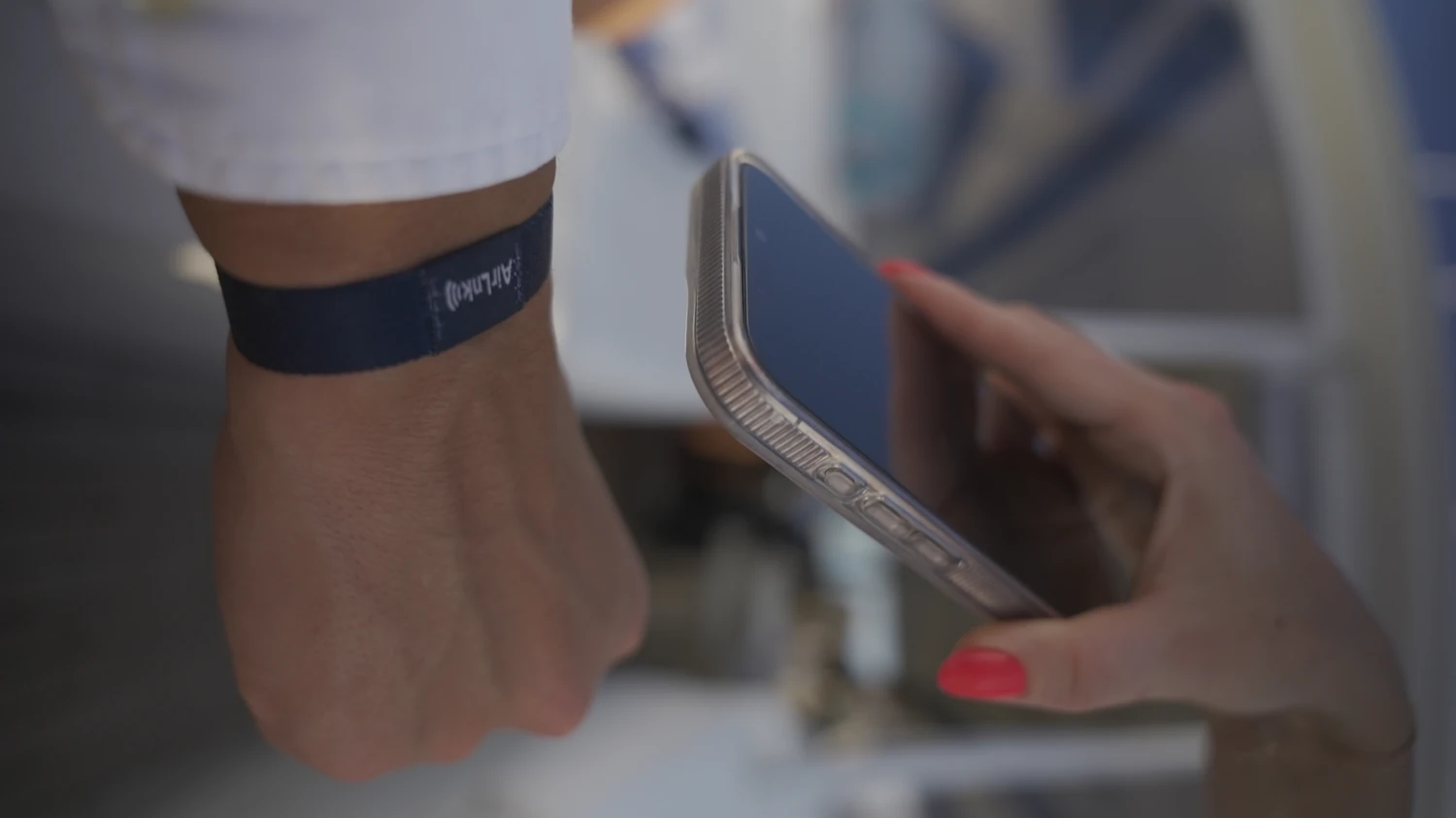 A phone held to the stitched AirLnk wristband patch